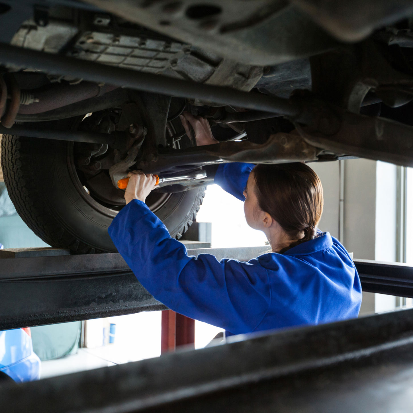 Female Mechanic Servicing Car